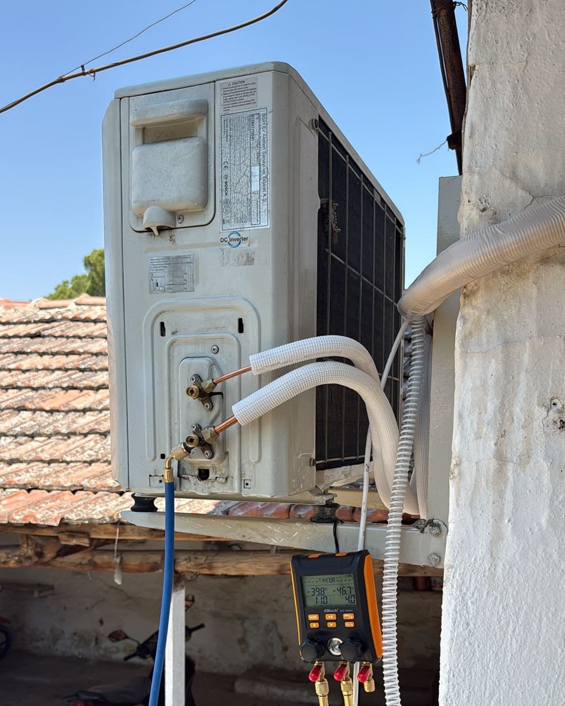 Bosch DC Inverter dış ünitenin servis vanasına bağlanmış Elitech dijital manometre; ekranda basınç ve sıcaklık değerleri okunuyor